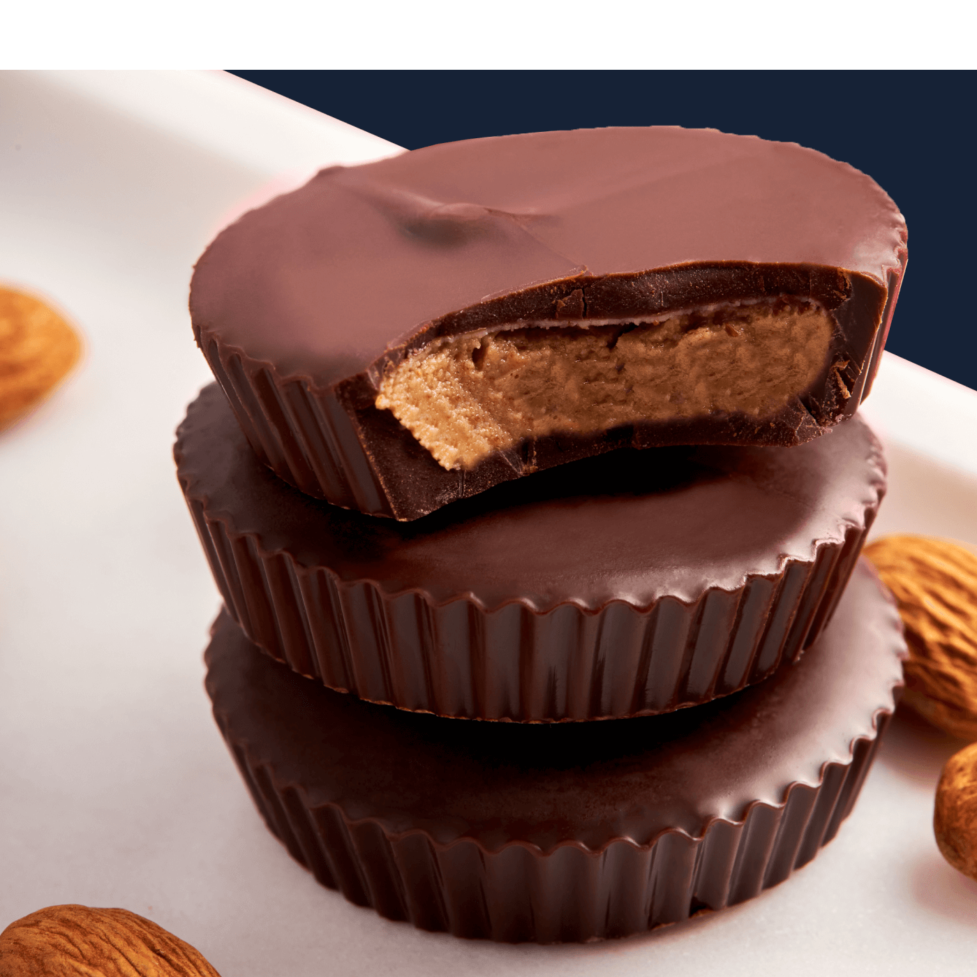 Stack of three mouth watering peanut butter cups made with ChocXO dark chocolate. 85% cacao, Keto Certified dark chocolate is “a chocoholics delight”.
